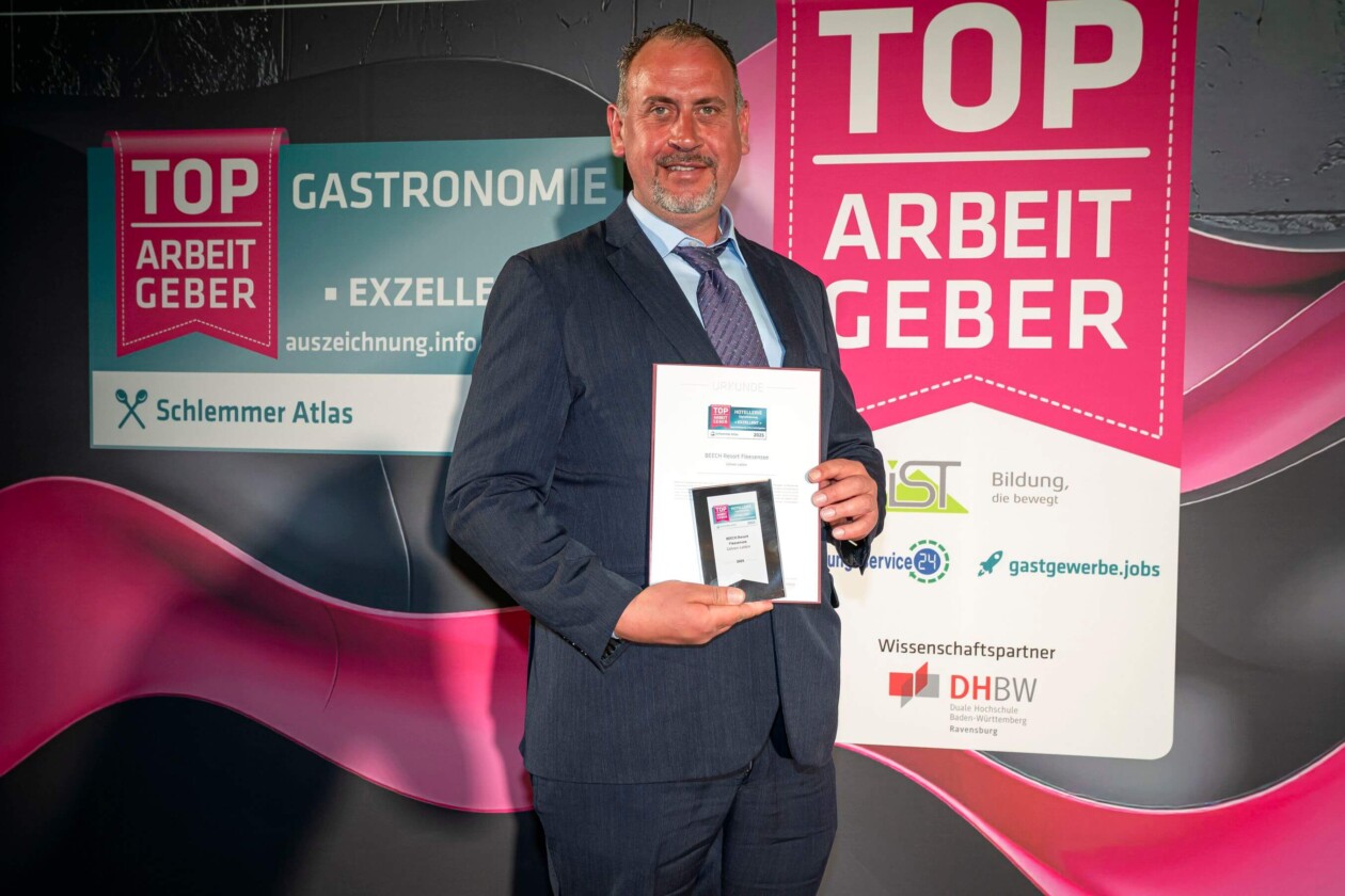 Mann hält Award in der Hand